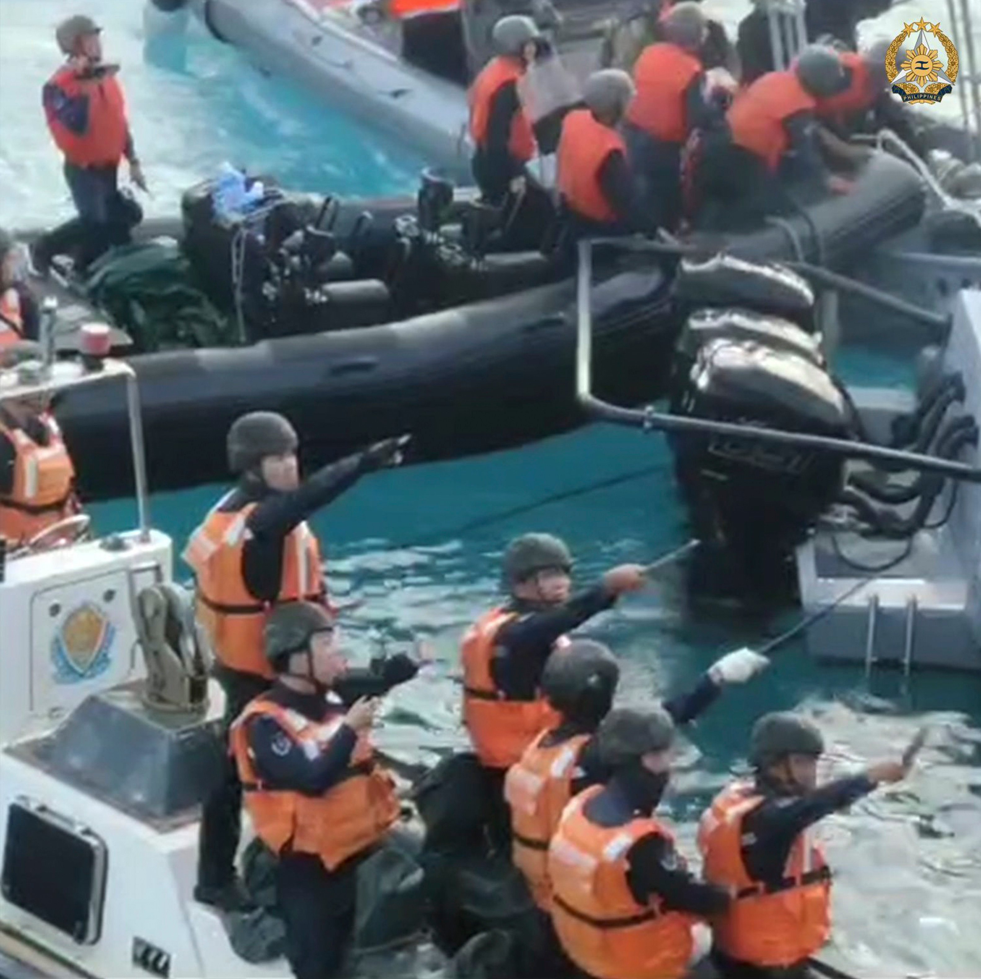 Chinese coastguard personnel brandish what appear to be knives, machetes and other weapons as they approach Philippine troops in the South China Sea on June 17. Photo: Armed Forces of the Philippines/Handout via AP